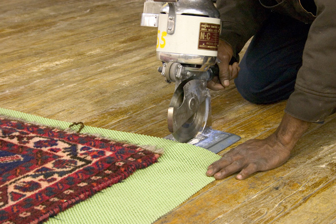 Photo of padding being cut for an area rug.